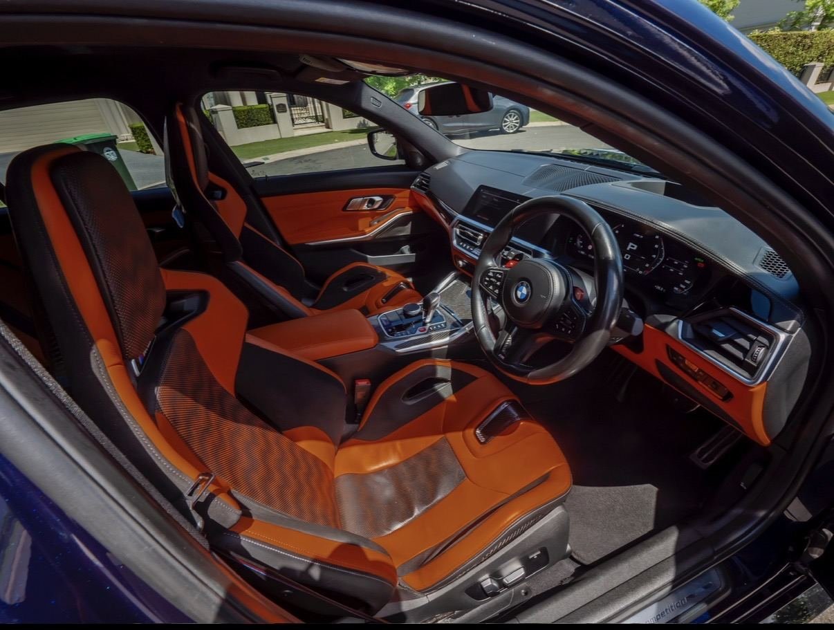 BMW interior with orange leather seats after detailing